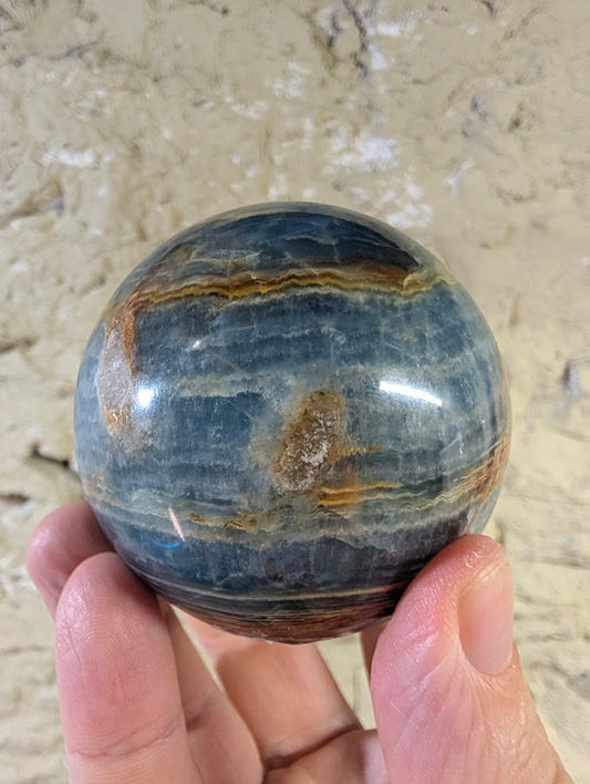 Angled view showing blue calcite layers and warm veining