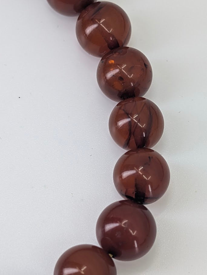 Baltic Amber Bead Bracelet – close-up showing high polish, internal inclusions, and warm glow
