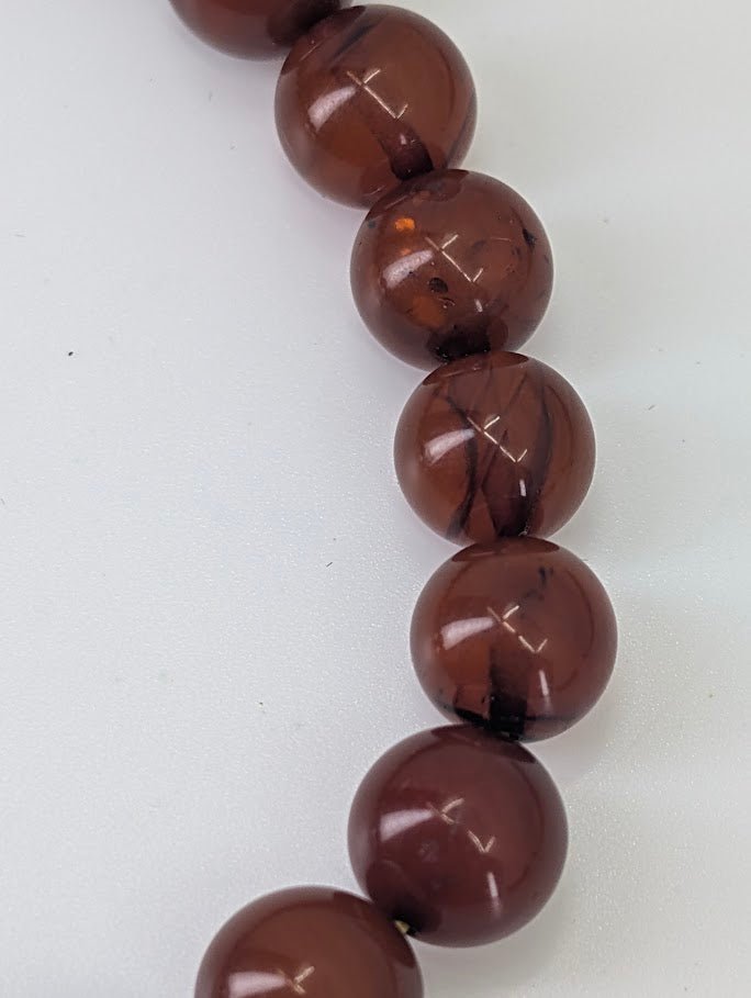 Baltic Amber Bead Bracelet – close-up showing high polish, internal inclusions, and warm glow