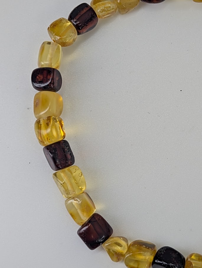 Close-up of Baltic Amber Bracelet 6 mm showing barrel-cut beads and internal inclusions