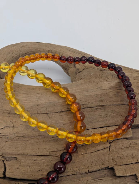 Baltic Amber Bracelets 4 mm and 4.8 mm – angled close-up showing polished transparency