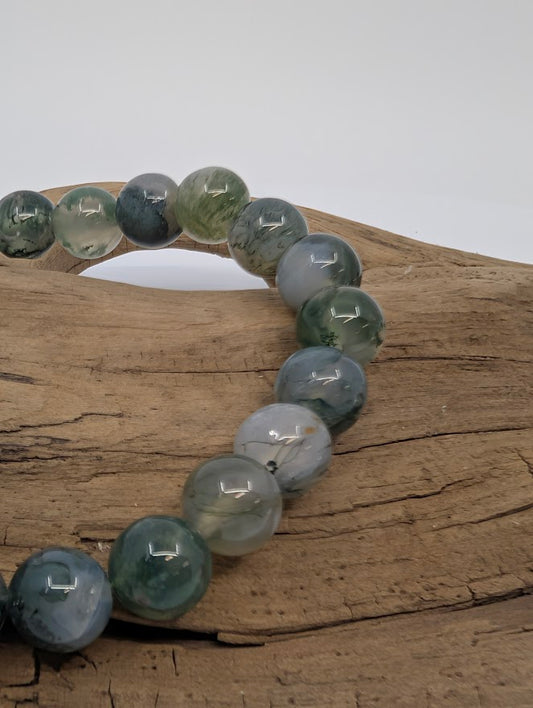 Close-up of Moss Agate beads showing green dendritic “moss” inclusions.