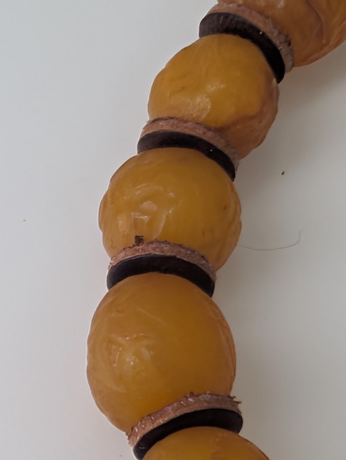 Close-up of Old Russian Amber Bracelet 8mm – visible inclusions, natural surface texture, and aged patina