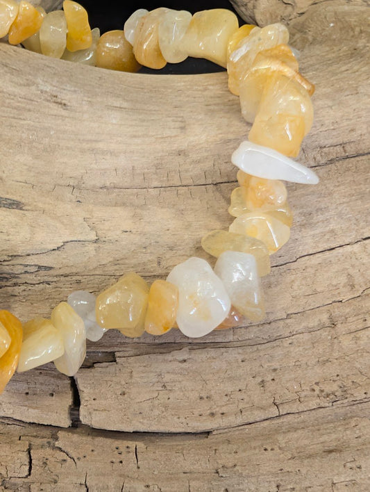 Close-up of polished Yellow Aventurine chips showing variations in golden-yellow translucency and honey-toned color.