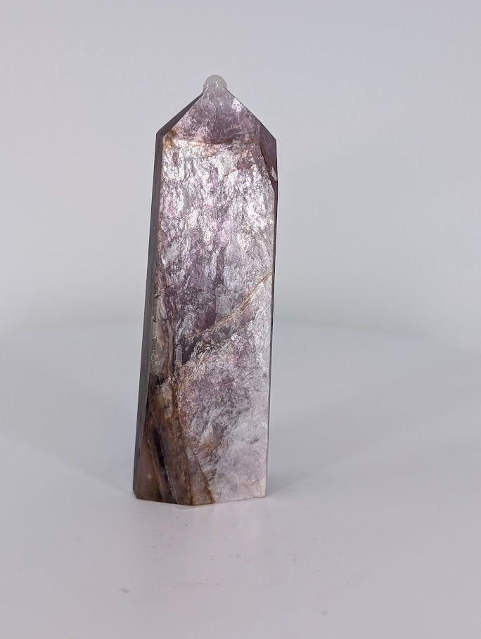 Angled view of Purple Mica Tower highlighting layered mica sheets and golden undertones.