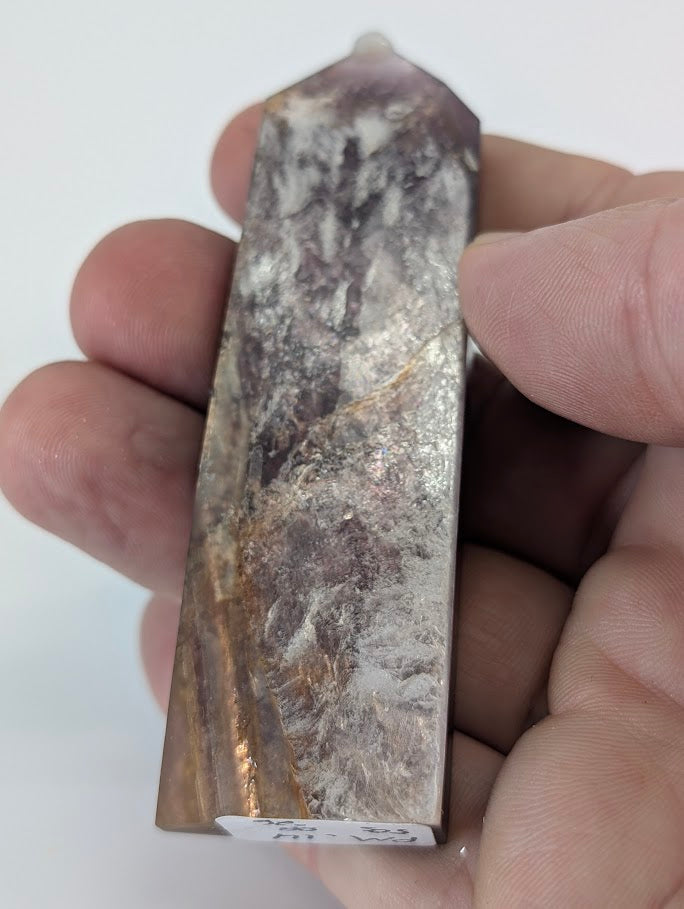 Close-up of Purple Mica Tower surface showing reflective mica layers, lavender shimmer, and fine golden lines.