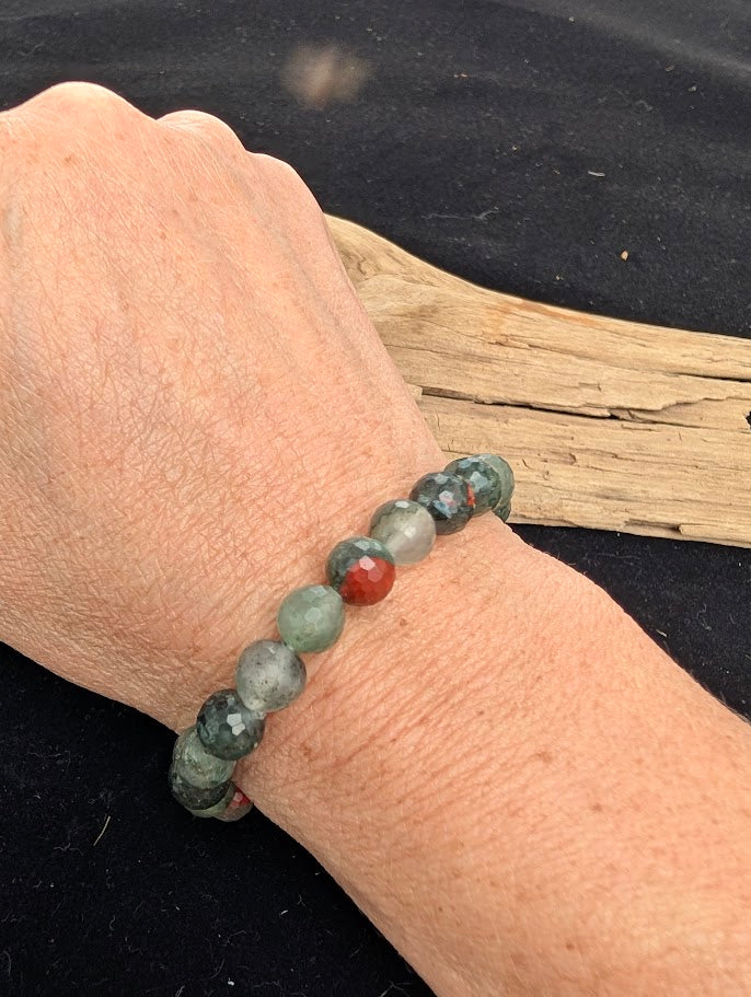 8mm faceted African Bloodstone beaded stretch bracelet worn on a wrist for size scale.