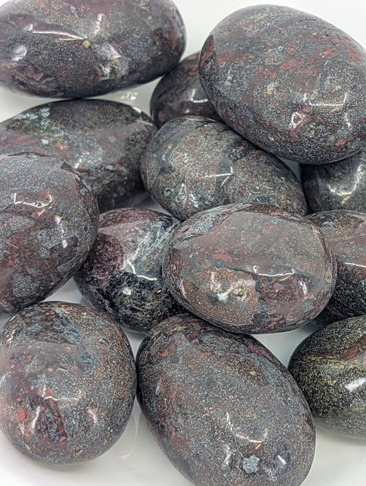 Close-up of African Bloodstone tumbled stones showing green and red marbling