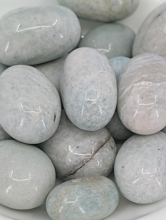 Close-up of Amazonite tumbled stones showing pale aqua color and feldspar shimmer