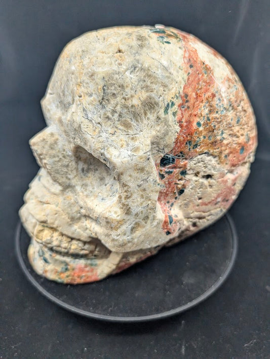 Angled left view showing vivid blue apatite windows and sunstone sparkle