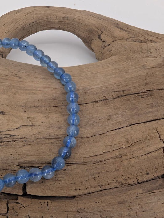 Close-up of 4mm Aquamarine bracelet showing translucent blue beads