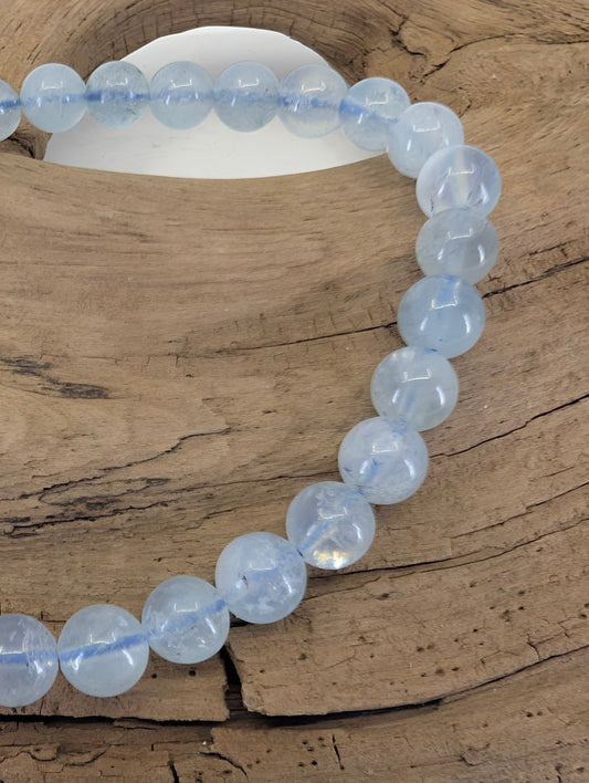 Close-up of 6mm Aquamarine beads highlighting natural semi-translucent beryl quality and light-blue tones.