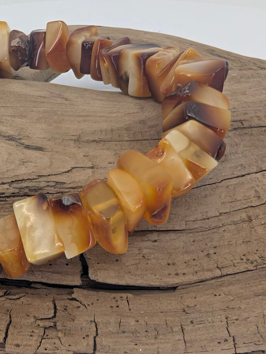 Closeup of genuine Baltic amber bracelet showing honey and cognac tones