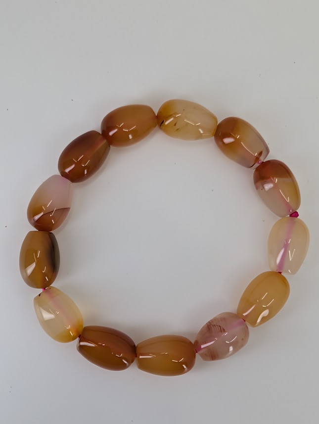 Flat-lay of banded agate bracelet highlighting color gradient and polish