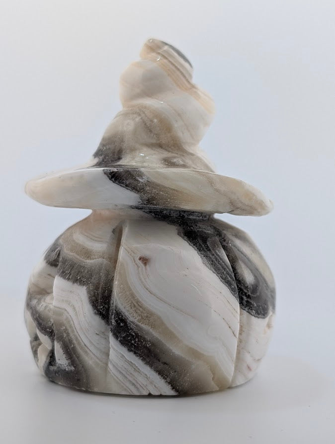 Side view of banded calcite pumpkin witch hat carving