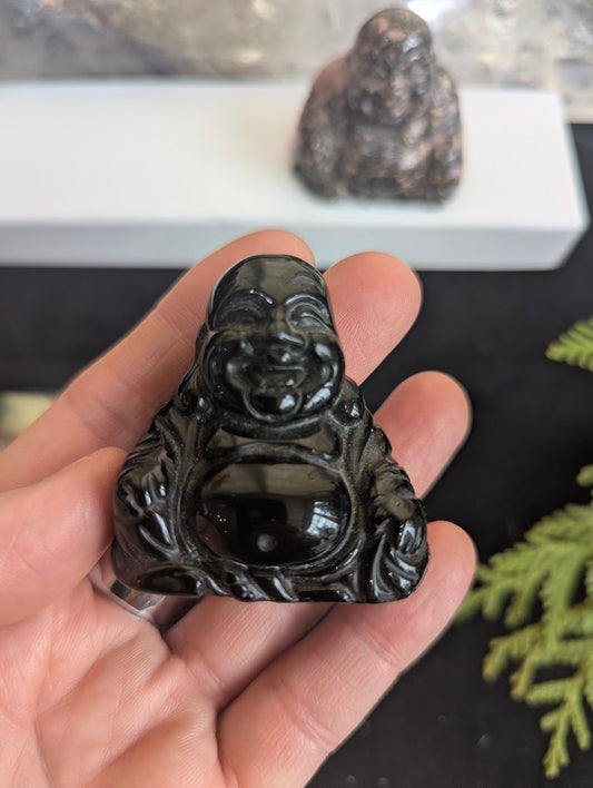 Front view of a polished Black Obsidian Laughing Buddha carving showing deep jet-black vitreous luster and mirror-like finish.