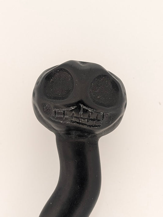 Close-up of carved skull face in black obsidian