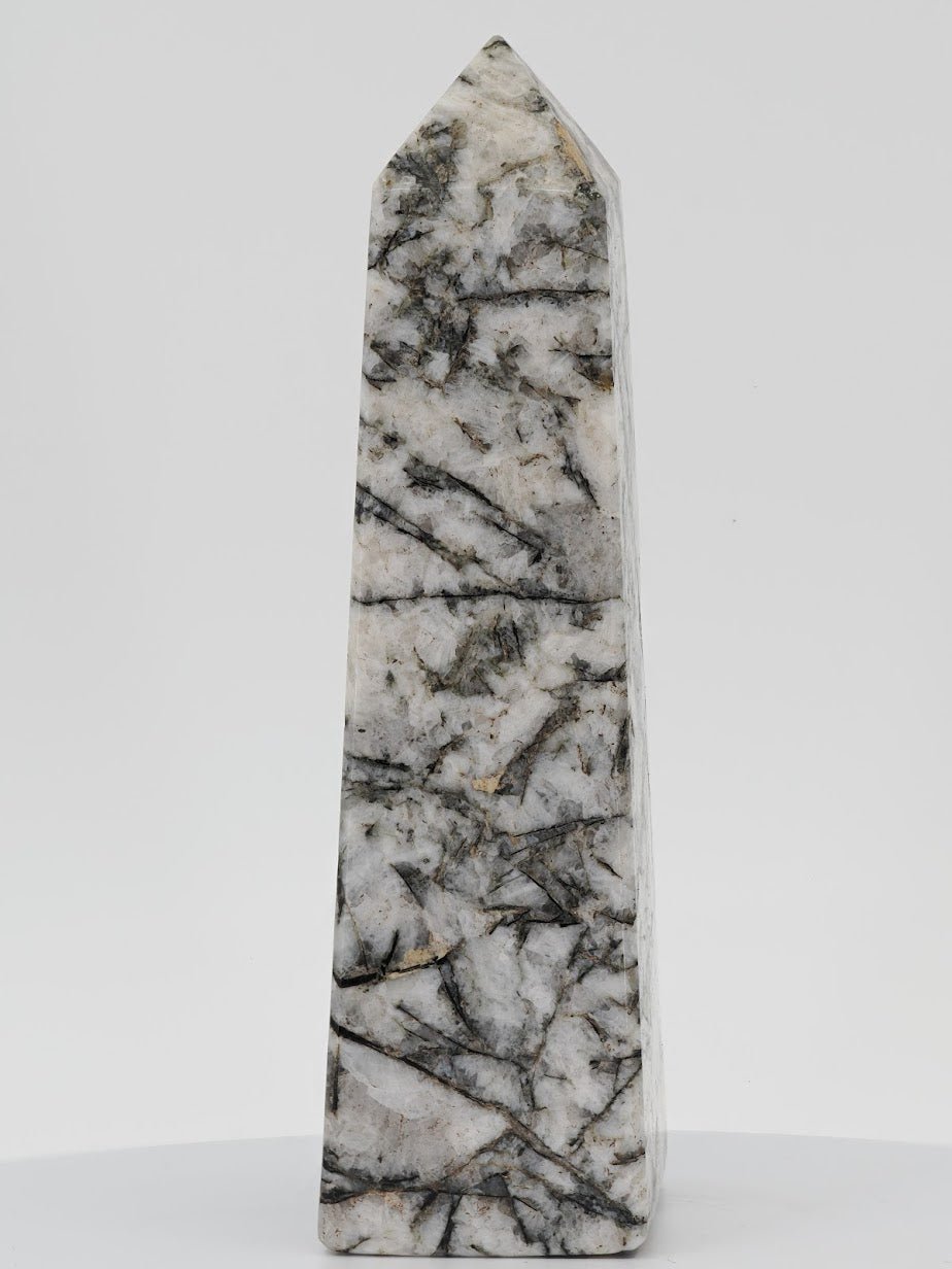 Polished monochromatic tower featuring black tourmaline needles embedded in white albite and quartz matrix.