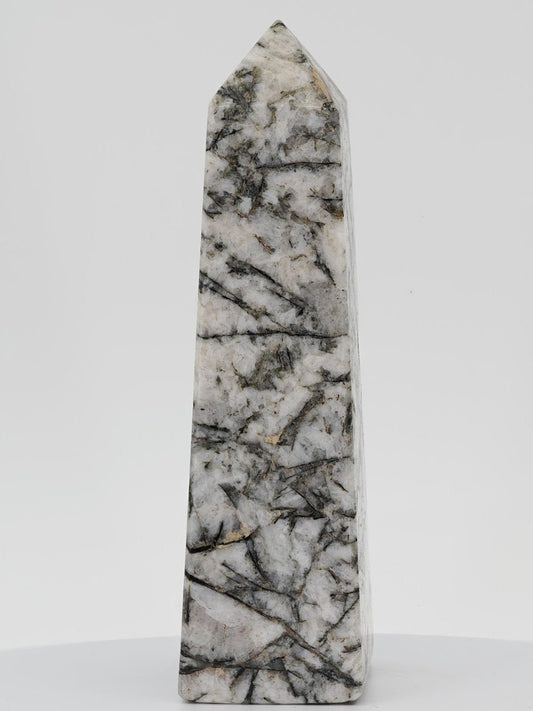 Polished monochromatic tower featuring black tourmaline needles embedded in white albite and quartz matrix.