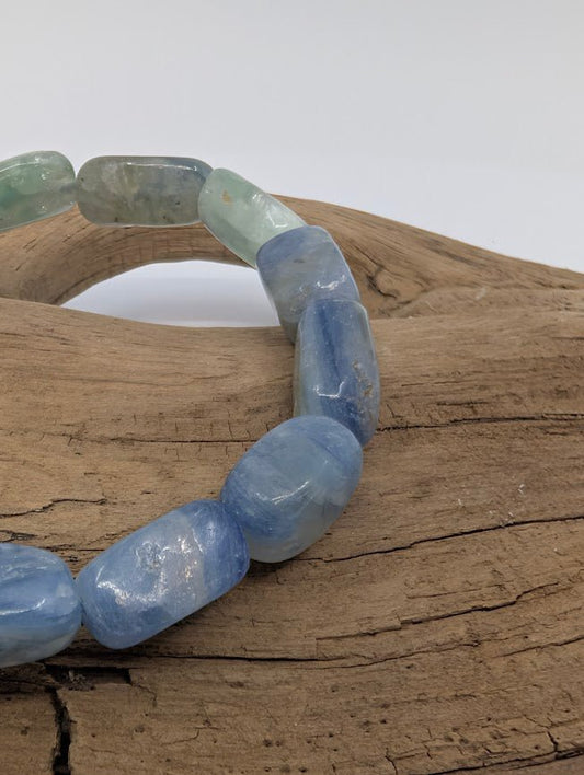 Close-up of Blue Kyanite free-form beads highlighting pearly luster and natural striations