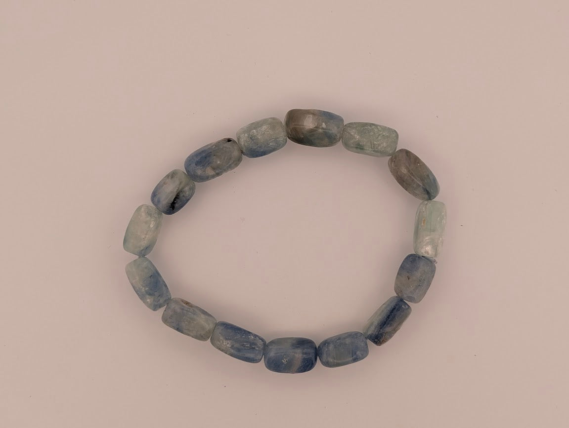 Overhead view of Blue Kyanite free-form bracelet on light background