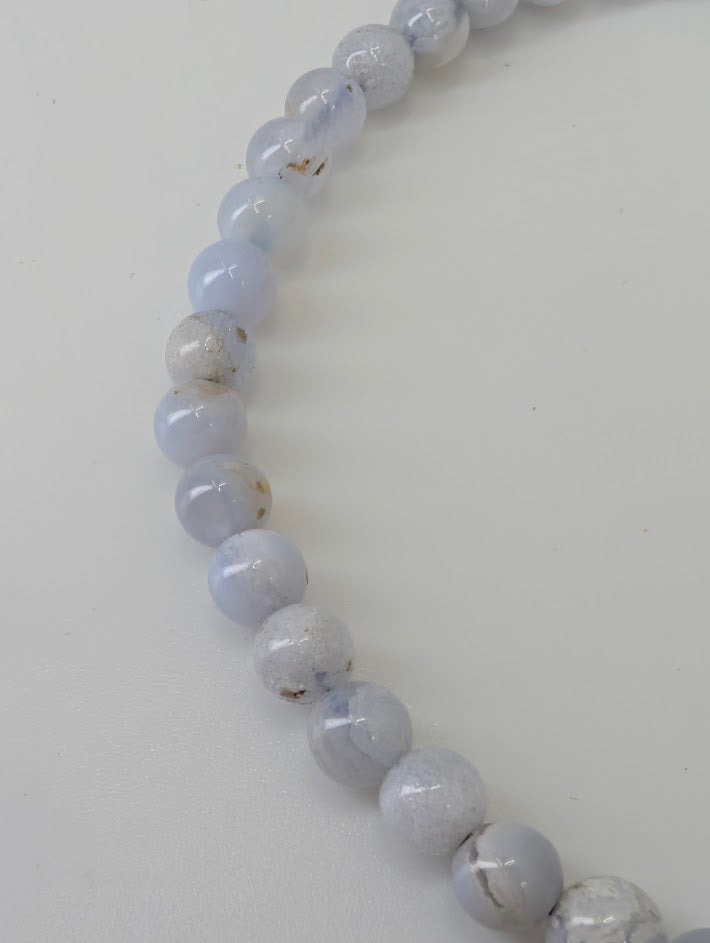 Detailed view of Blue Lace Agate beads showing subtle banding and polish