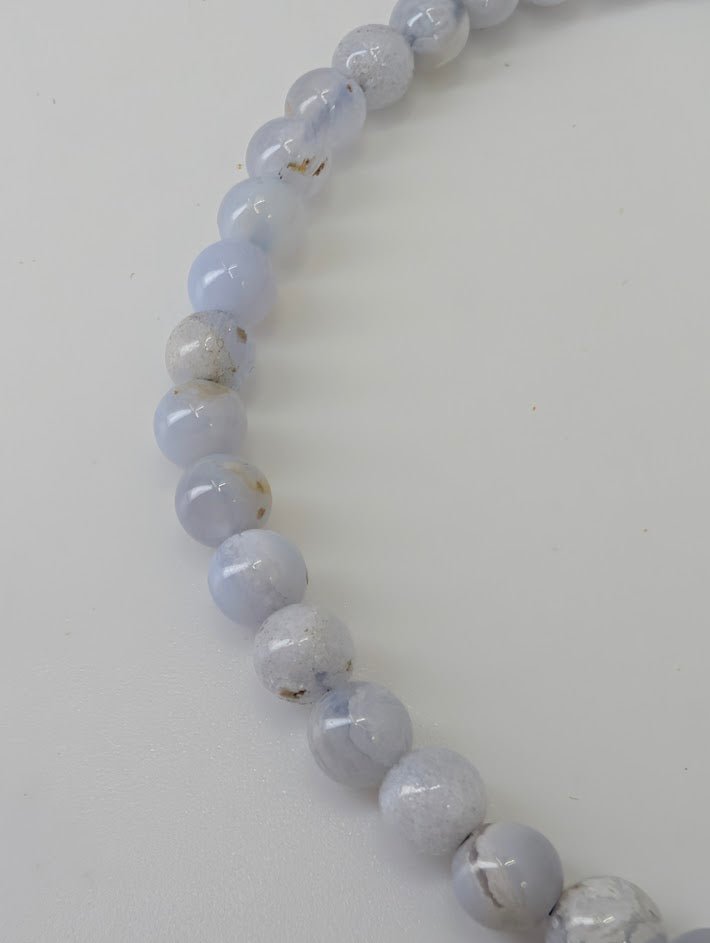 Detailed view of Blue Lace Agate beads showing subtle banding and polish