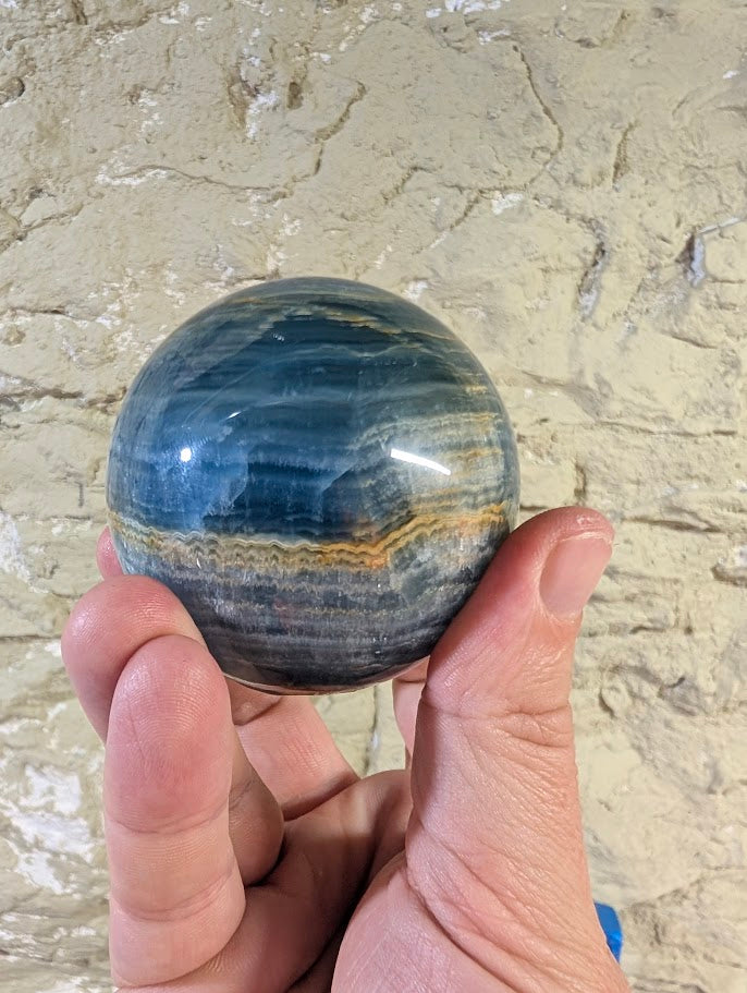 Close-up showing golden brown seam across blue onyx surface