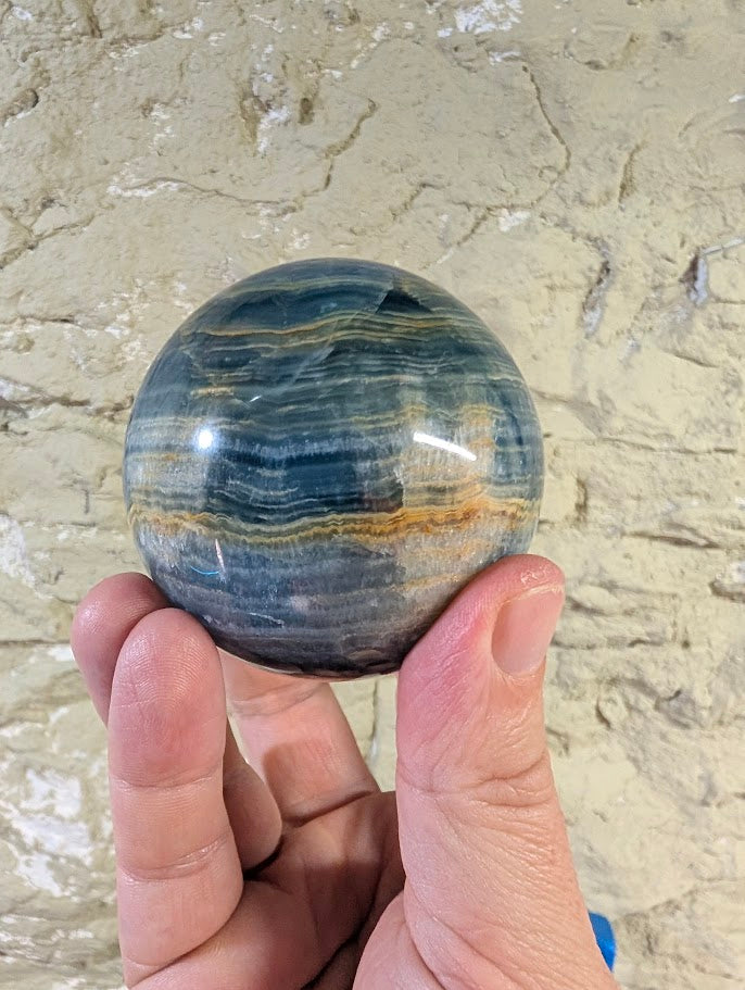 Top view of sphere with layered blue tones and smooth finish