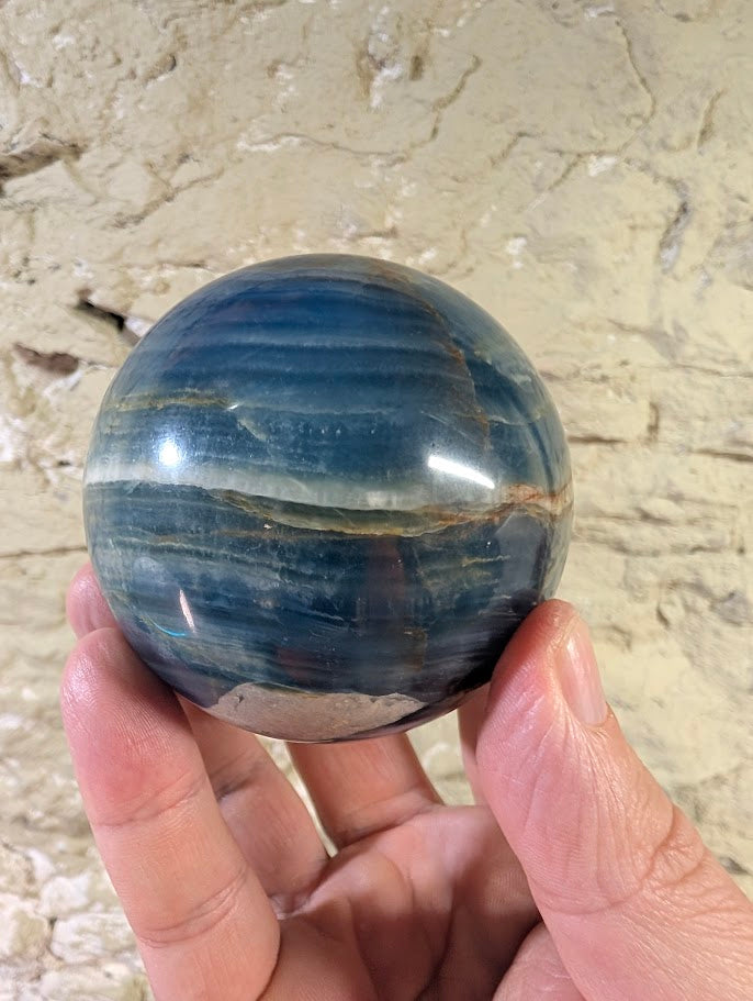 Horizontal view showing white equator banding and deep blue layers