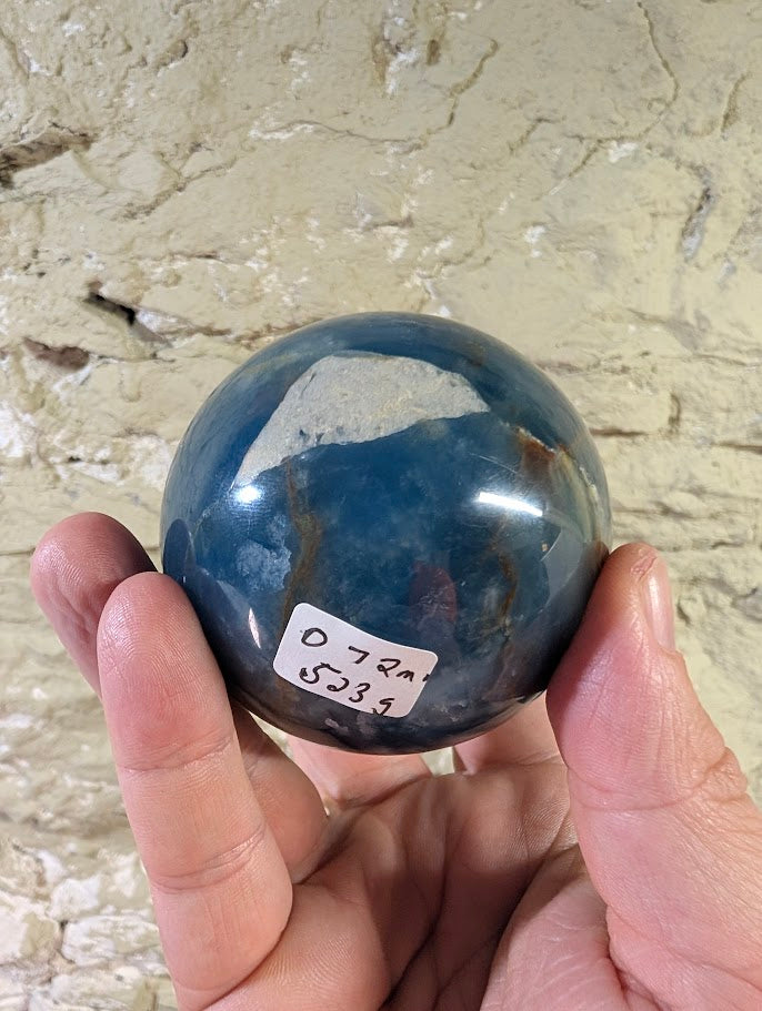 Raw base of the sphere showing natural calcite matrix and polish line