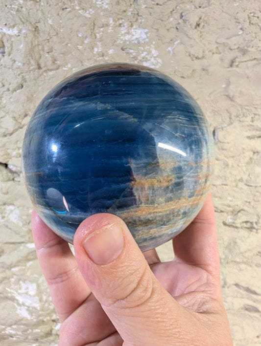 Deep blue side of the sphere showing fine linear calcite banding