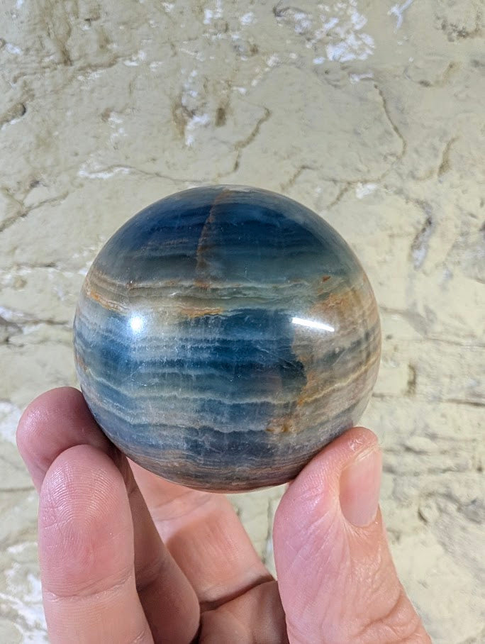 Side view showing layered banding of Blue Onyx Sphere 60mm