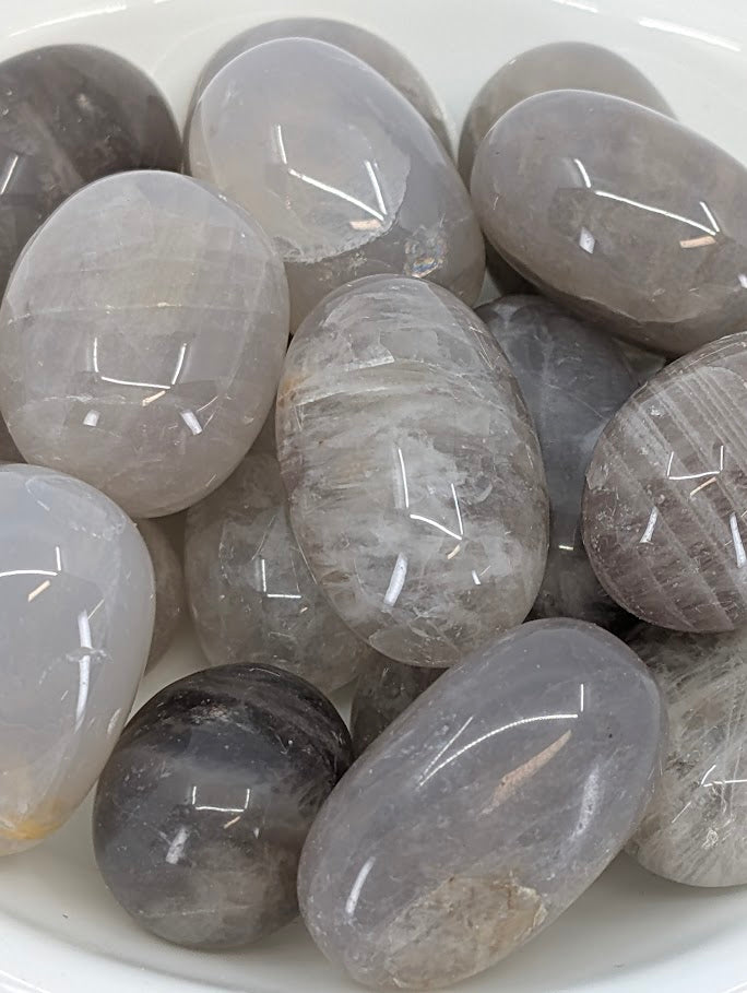 Close-up of Blue Rose Quartz tumbles showing high polish and tone