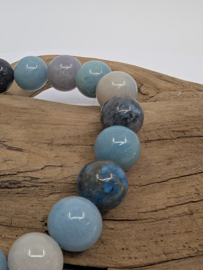 Close-up of Blue Trolleite beads showing sky-blue and grey marbling.