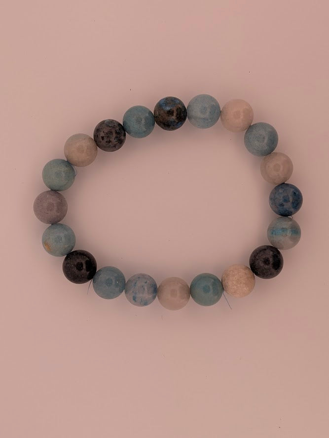 Blue Trolleite beaded bracelet laid flat in a circle, 9.5mm beads.