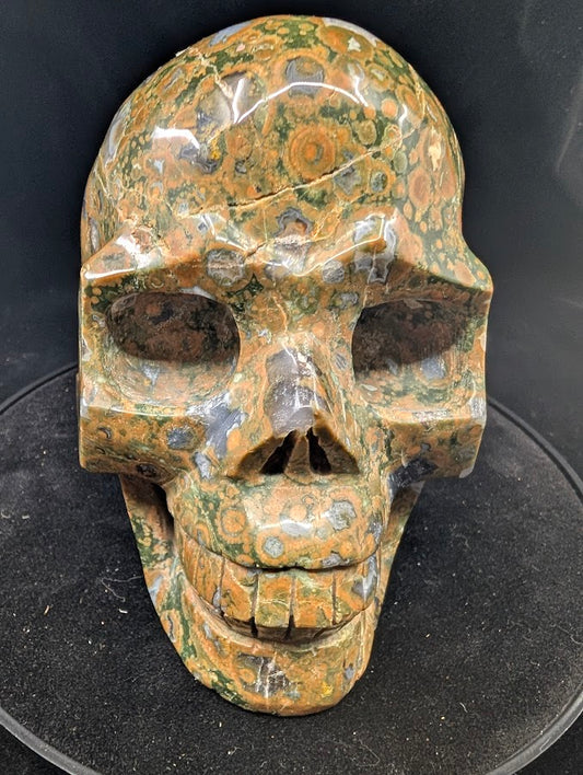 Front view — 2.45 kg Cambaba Jasper Skull with polished green and black orbs