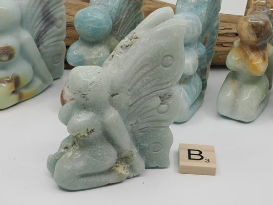 Caribbean Calcite fairy carving B with natural crystal vugs and frosted blue texture.