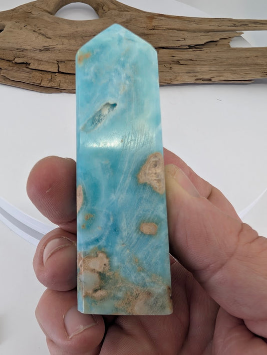 Handheld scale reference of Caribbean Calcite tower approximately 3 inches tall and 150 grams