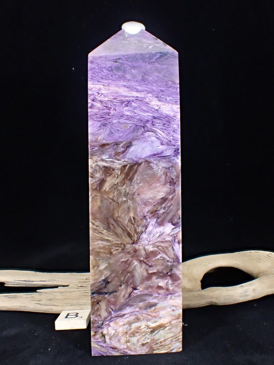 Close up of the golden-bronze Tinaksite blades radiating through the purple stone on Tower B.