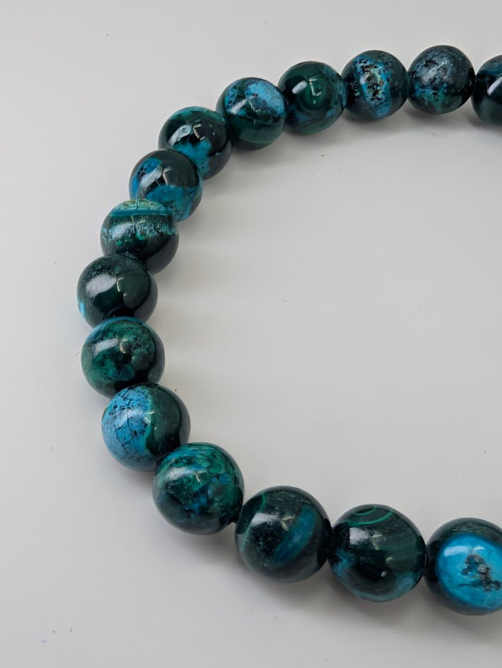 Detailed view of Chrysocolla beads showing teal and turquoise tones