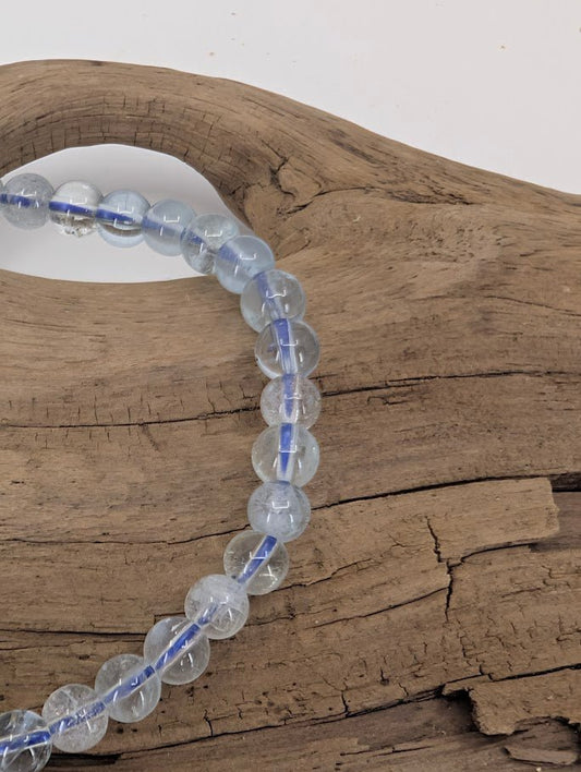 Close-up of clear aquamarine beads showing natural clarity