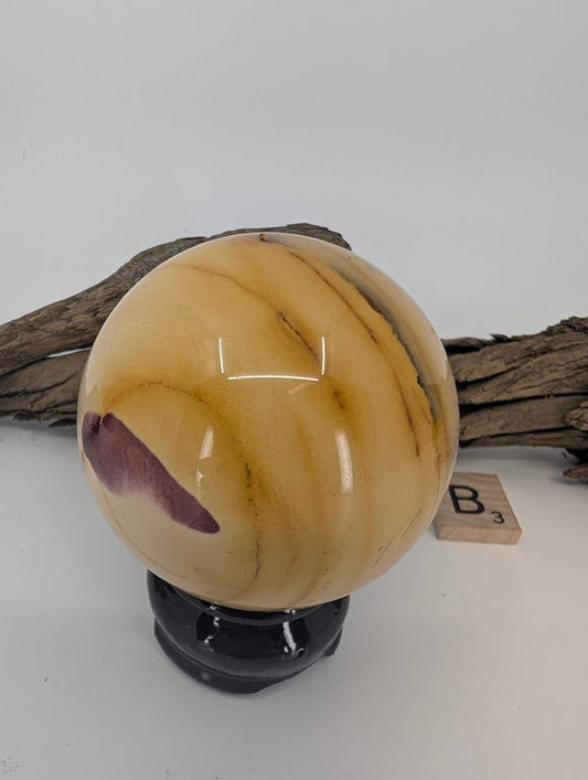 Side profile of Mookaite sphere B showing natural sedimentary banding.
