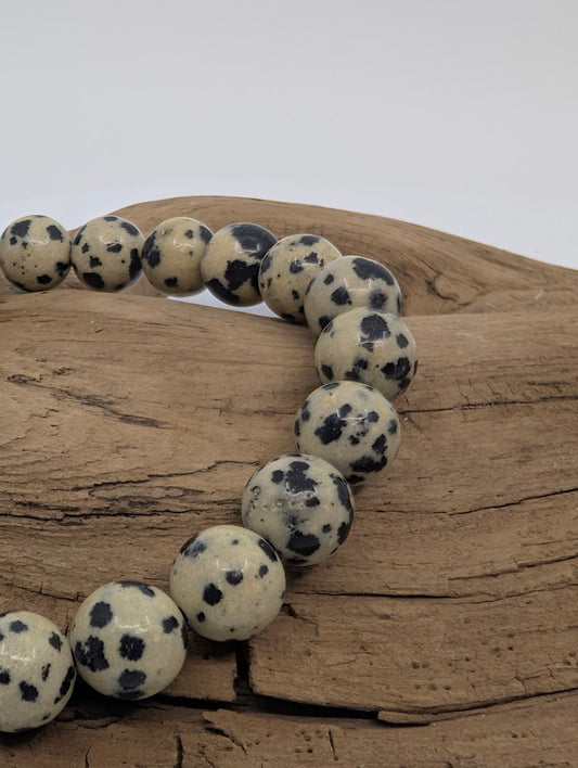 Close-up of Dalmatian Jasper beads showing natural black spots