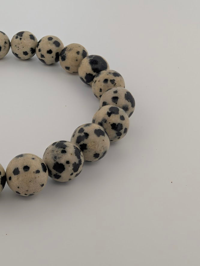 Polished 8mm Dalmatian Jasper beads with high-contrast spotted pattern