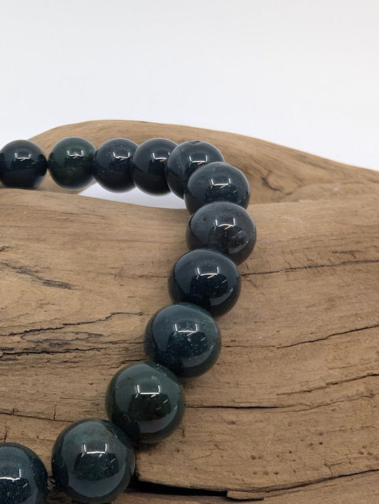 Close-up of Dark Moss Agate beads showing glossy finish and mossy veils