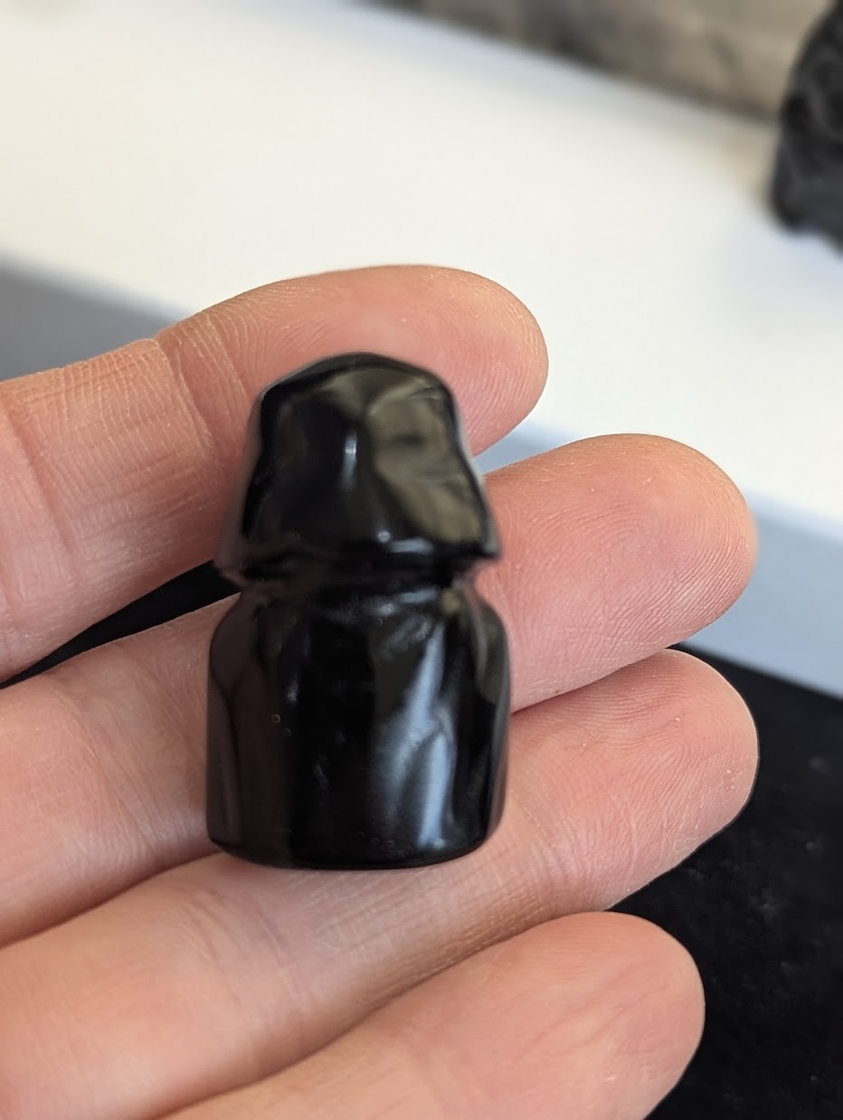 Rear view showing the smooth cape detail of a hand-carved Black Obsidian Darth Vader.