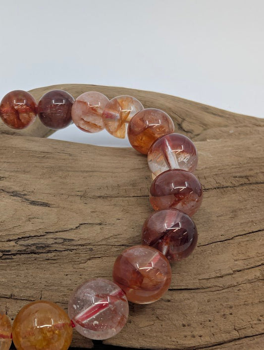 Close-up of Fire Quartz beads showing hematite flames and high polish