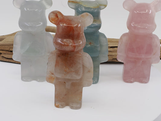 Front view of a Fire Quartz designer bear carving featuring vibrant red hematite inclusions in clear quartz.