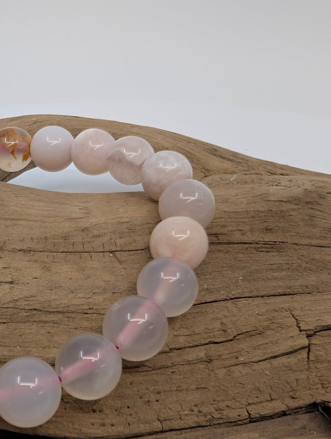 Macro of Flower Agate beads with translucent pink base and crisp white plumes